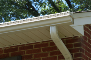 White gutter system installed on the roofline of a house