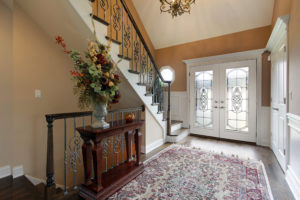 Foyer in suburban home with a glass front entry door