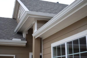 A white gutter system installed along the roofline of a home